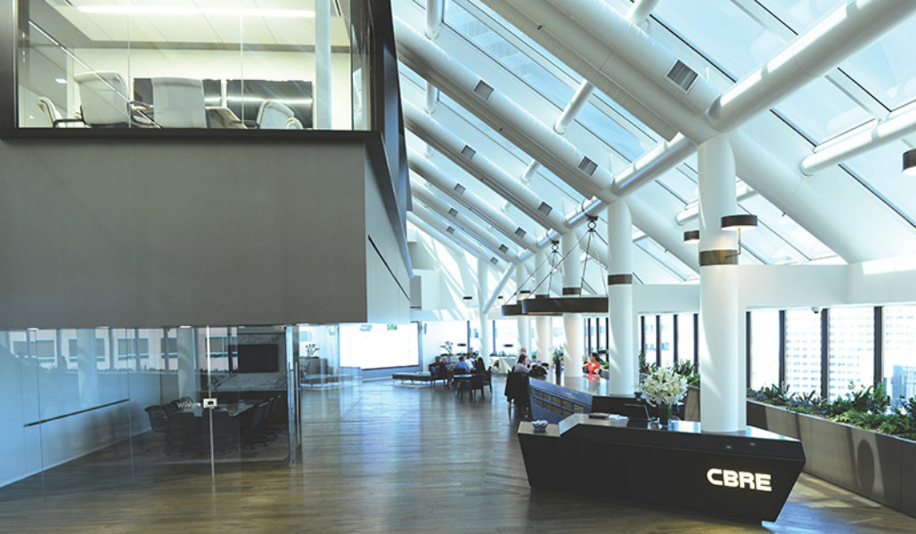 The glass-enclosed atrium at CBRE's wellness-certified global headquarters, Los Angeles